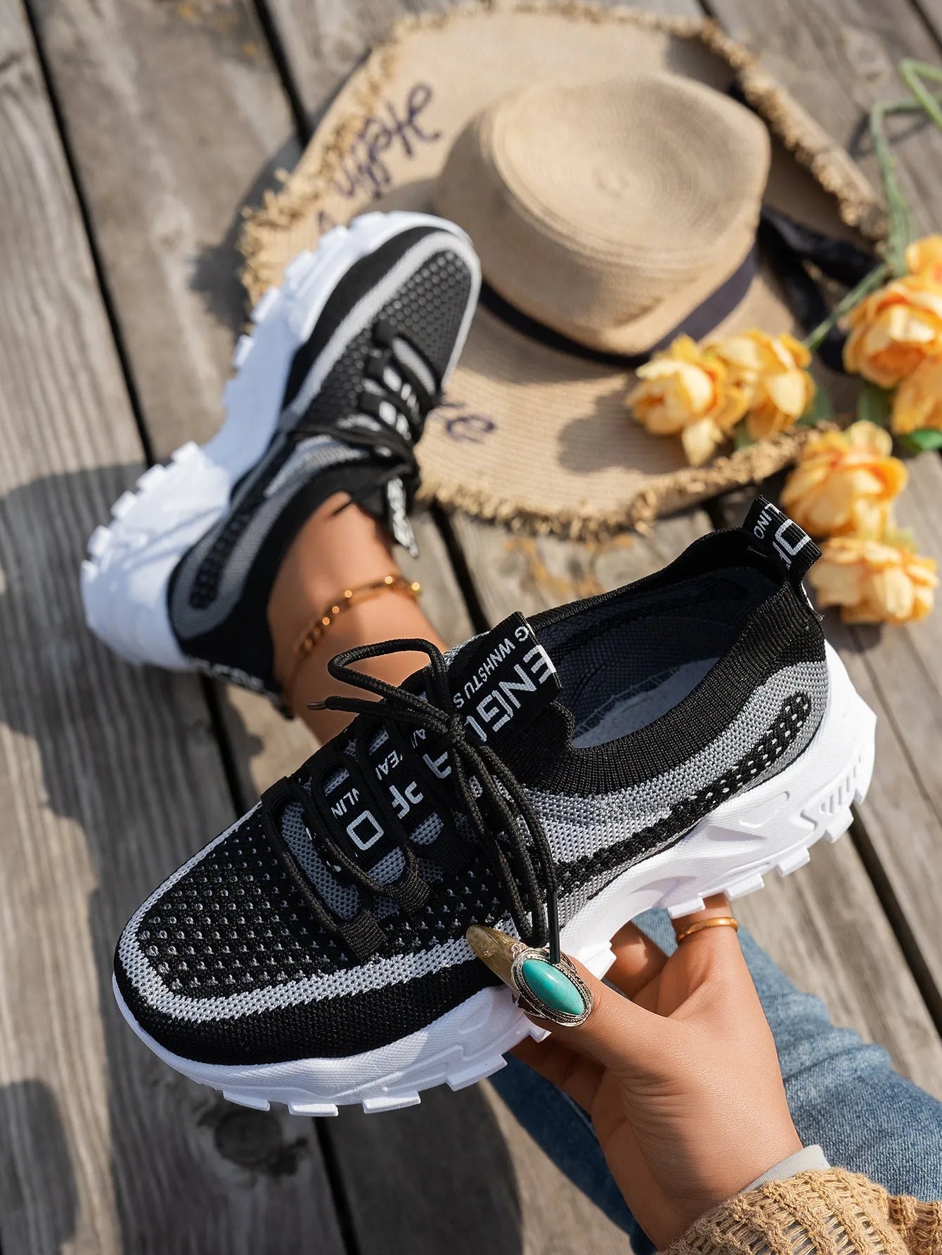 Women's Flyknit mesh lace-up sneakers in a selection of colours, showing round toe and flat rubber sole.