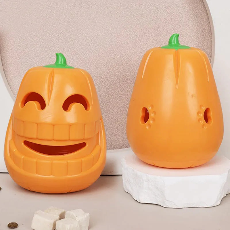 Orange Halloween pumpkin shaped durable rubber dog toy with a treat-dispensing funnel opening.
