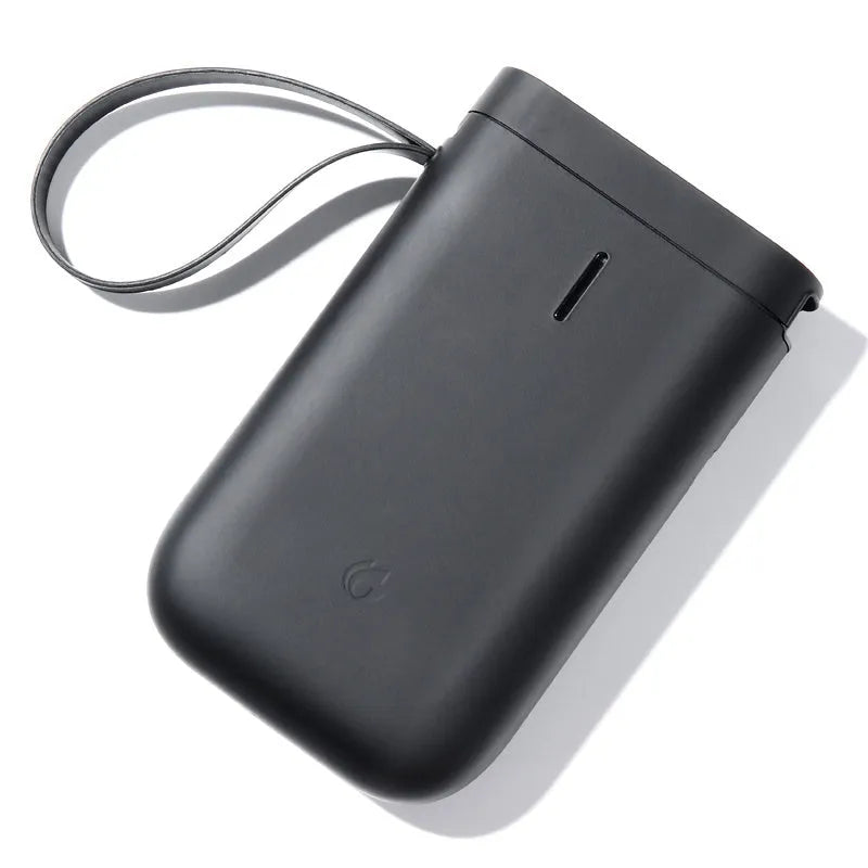 Compact D11 Bluetooth thermal label printer in black, white, pink, or green with smartphone showing label design app.