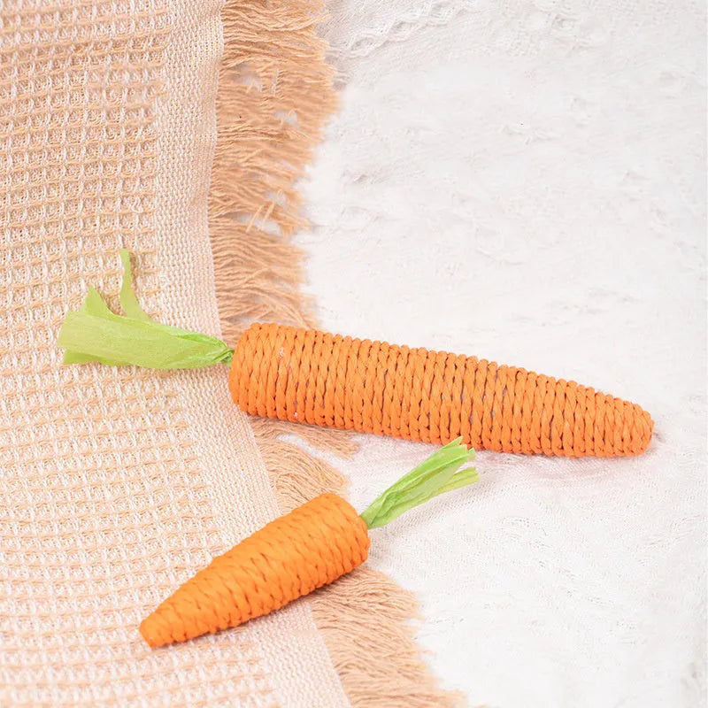 Set of interactive cat toys including paper carrot bites, sticks, and toys with ringing stones.