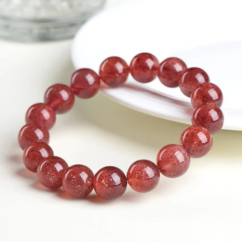Natural starlight cherry red strawberry quartz bracelet with geometric beads on wrist