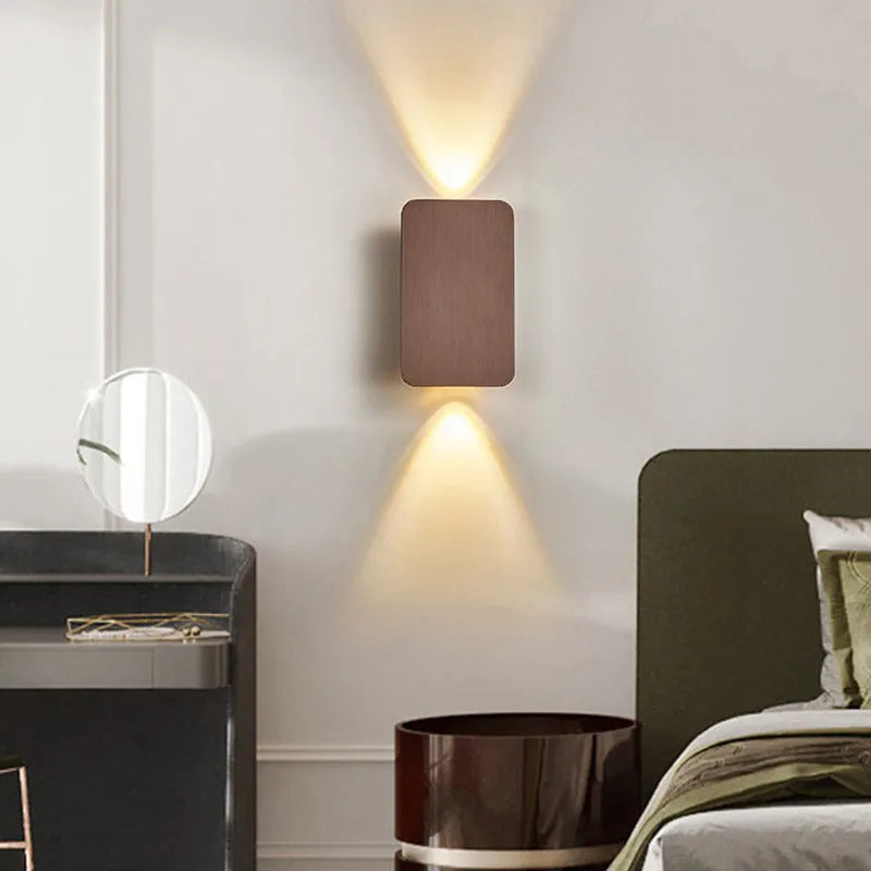 Modern Nordic minimalist LED wall lamp mounted beside bed showing black finish and warm light illumination
