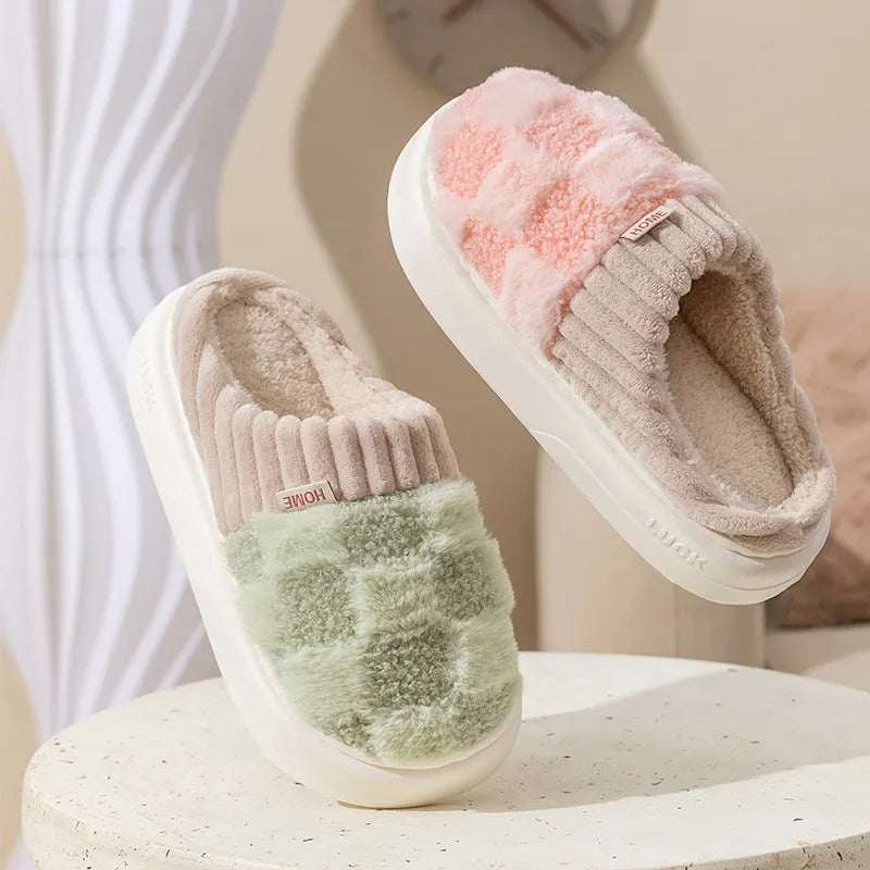 Women's plaid patterned plush slippers with non-slip sole in multiple colours on a wooden floor.