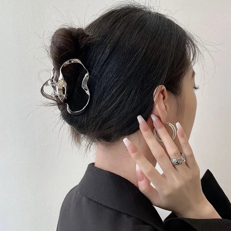Electroplated silver metal hair barrettes in various designs including cross, wave, and bow shapes.