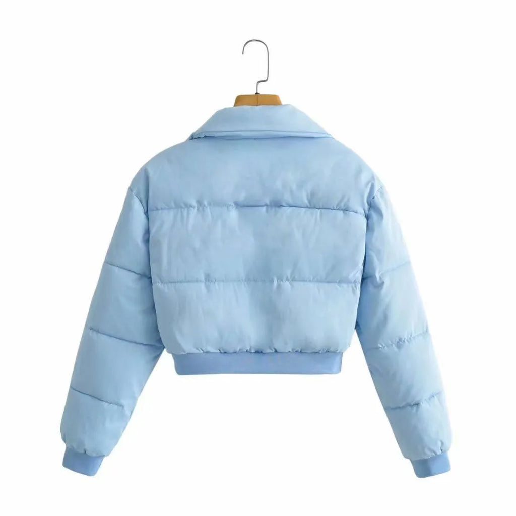 Loose fit blue polyester jacket for women on a hanger, showing long sleeves and front closure.