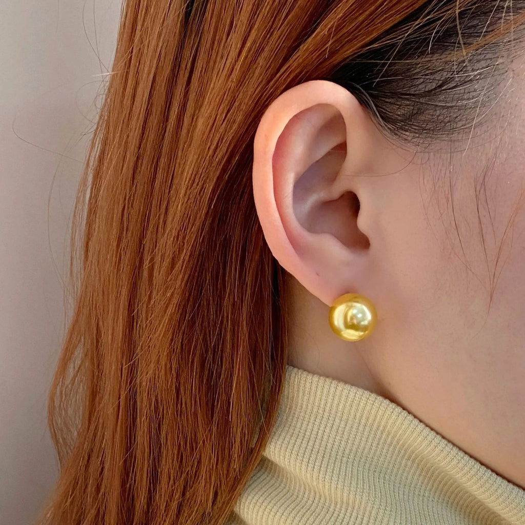 Large geometric pearl stud earrings for women with an eight-point star detail, shown in silver.