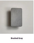 Modern Nordic minimalist LED wall lamp mounted beside bed showing black finish and warm light illumination