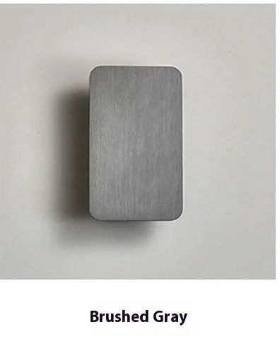 Modern Nordic minimalist LED wall lamp mounted beside bed showing black finish and warm light illumination
