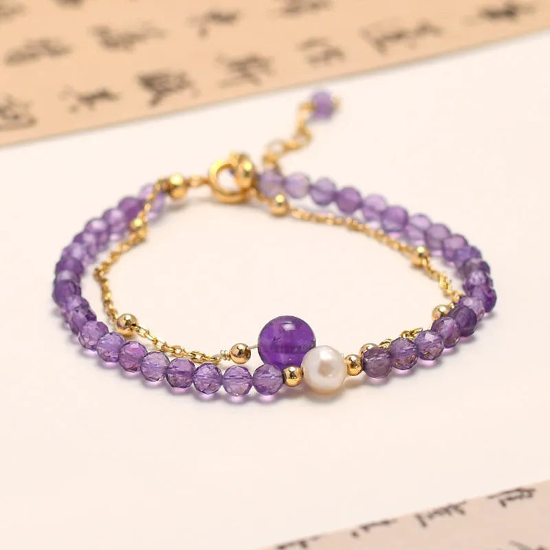 Chinese style women's bracelet with electroplated metal and amethyst crystal stones cut in diamond shapes.