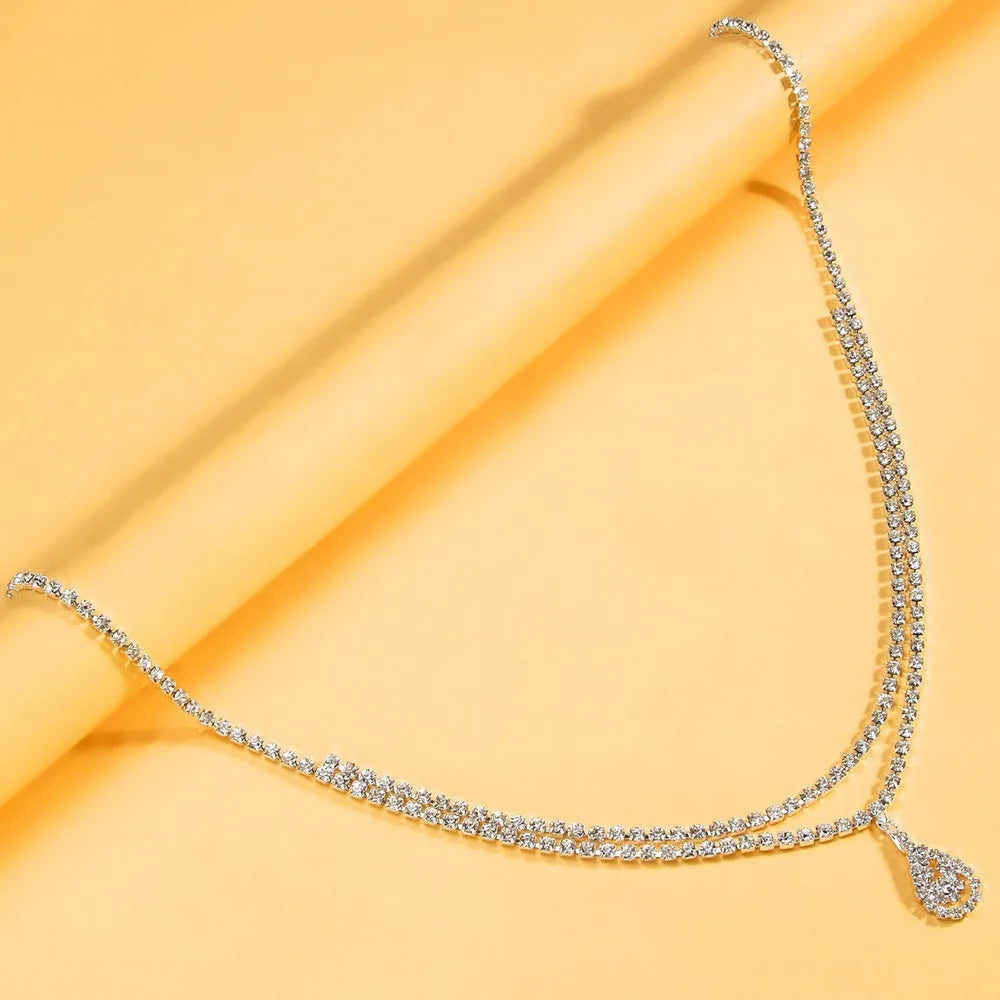 Gold waist chain with rhinestone water drop pendant and adjustable lobster clasp