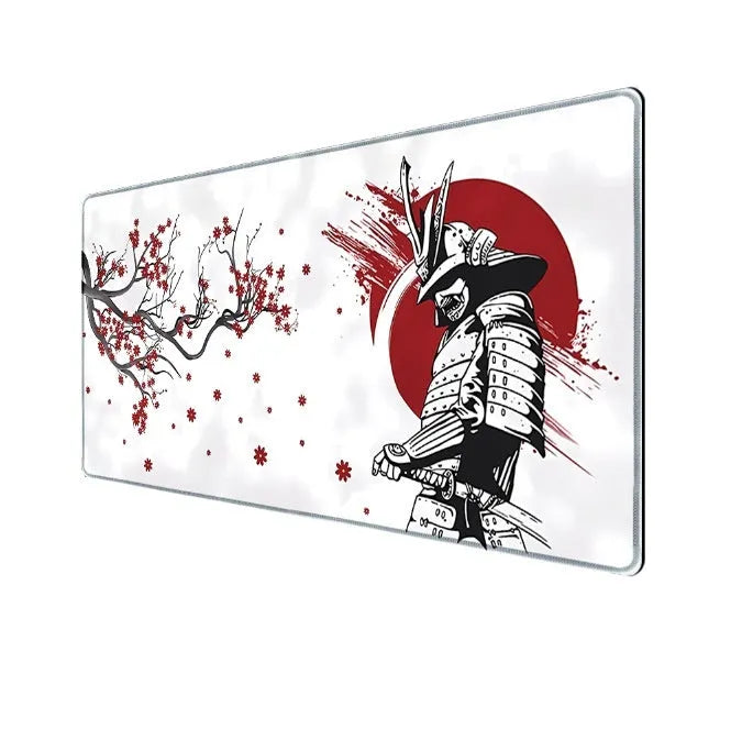 Japanese samurai design gaming mouse pad with cloth surface on a desk.
