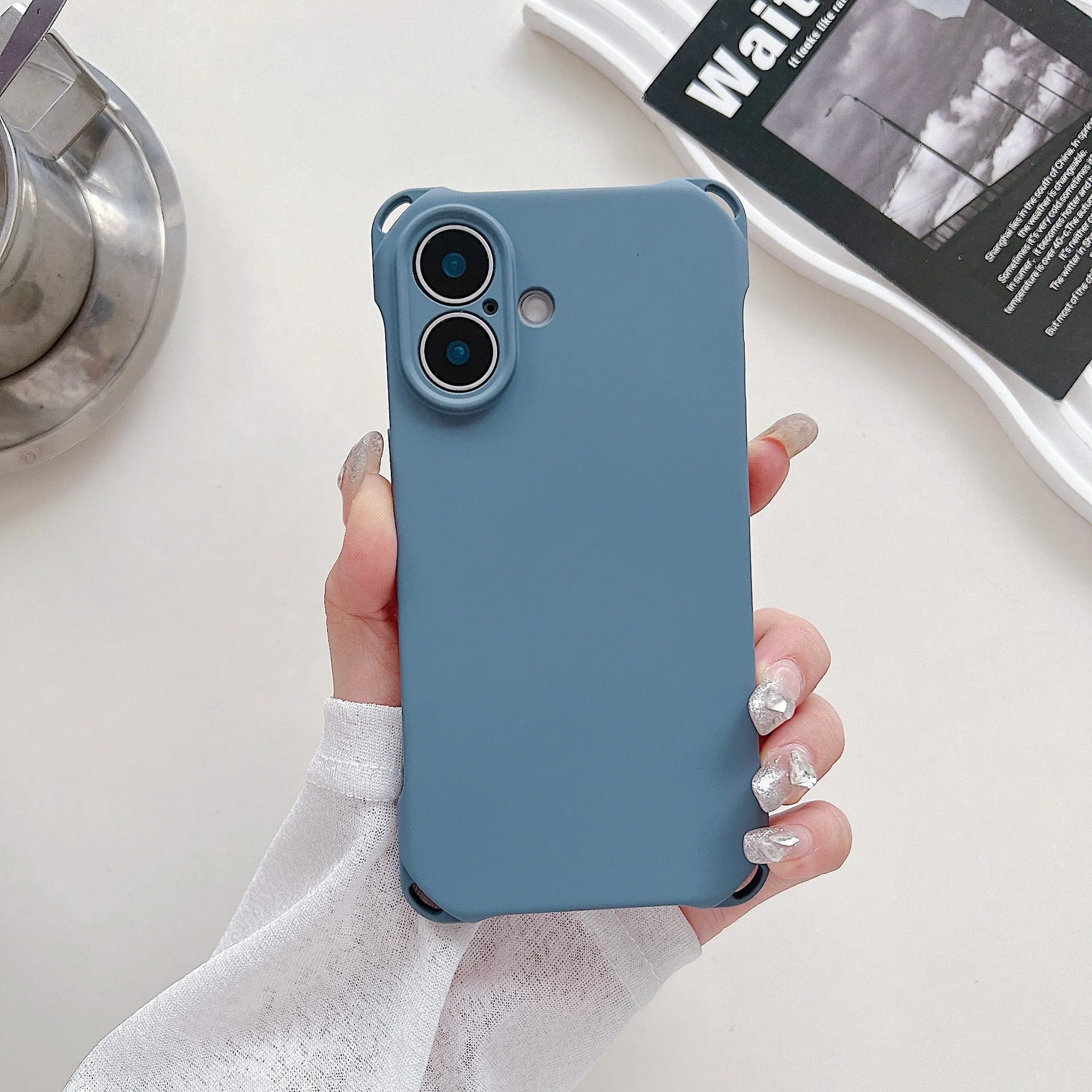 Four-corner cross lanyard liquid silicone phone case for Apple iPhone 16 in antique white with matching lanyard