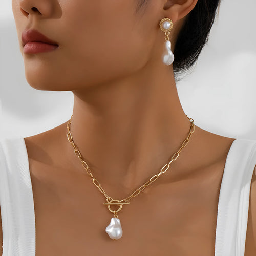 Gold-colour baroque pearl necklace and stud earrings jewellery set on display