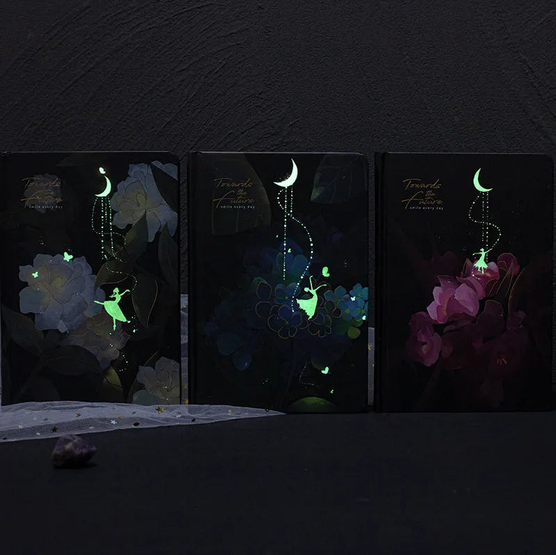 A5 notebook with luminous cover showing colour illustration pages inside, available in Deep Blue, Gold, Light Blue, or Purple colours