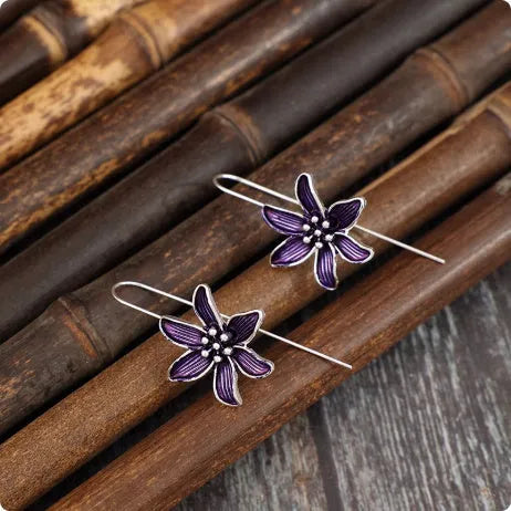 A pair of retro-style purple flower earrings made from lightweight alloy with an electroplated finish.
