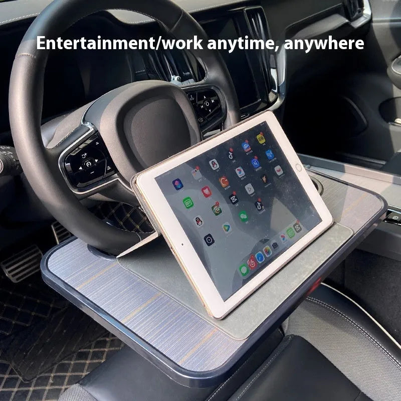 Foldable black car tray stand with cup holder on a car passenger seat