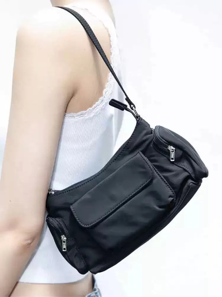 Black lightweight PU women's shoulder bag with two front pockets showing side stitching detail