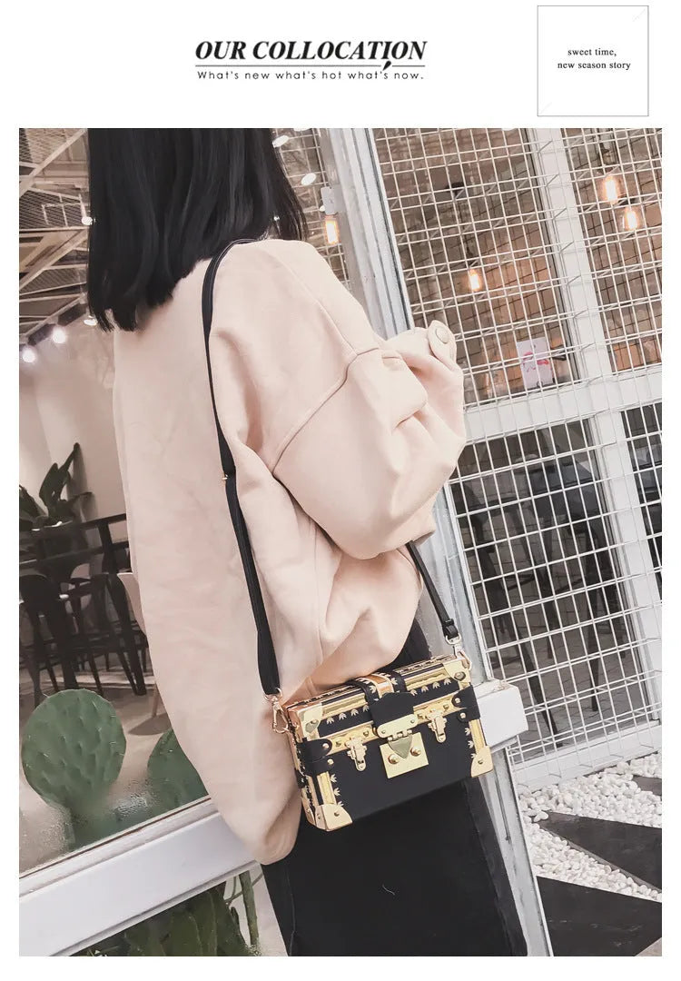 Black or green women's hard-shell flap-over shoulder bag with single adjustable strap