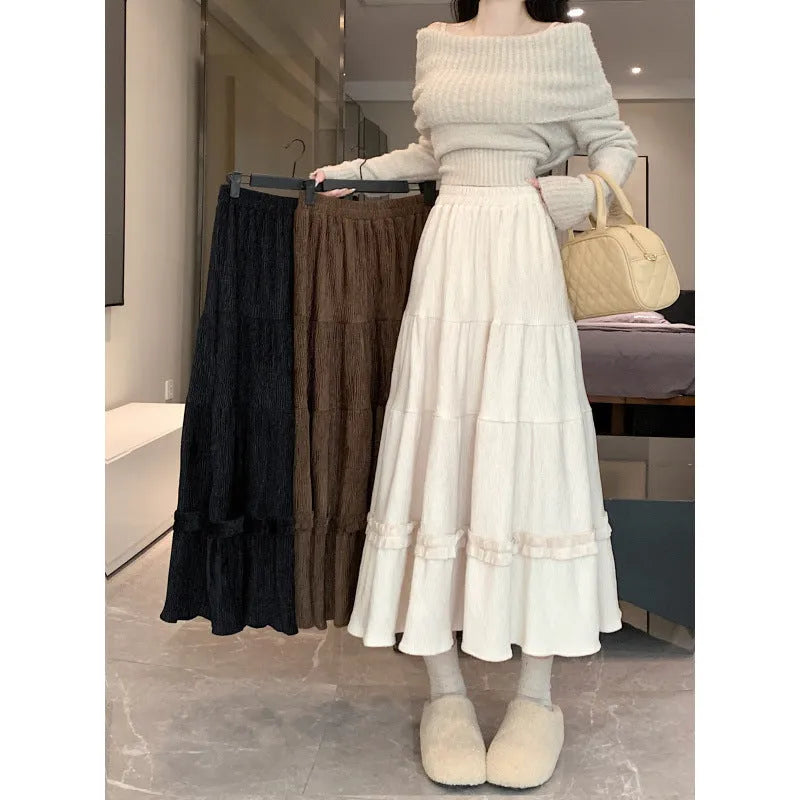 Korean urban style corduroy A-line midi skirt with elastic waistband in milky white colour on a hanger.