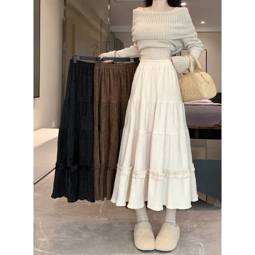 Korean urban style corduroy A-line midi skirt with elastic waistband in milky white colour on a hanger.