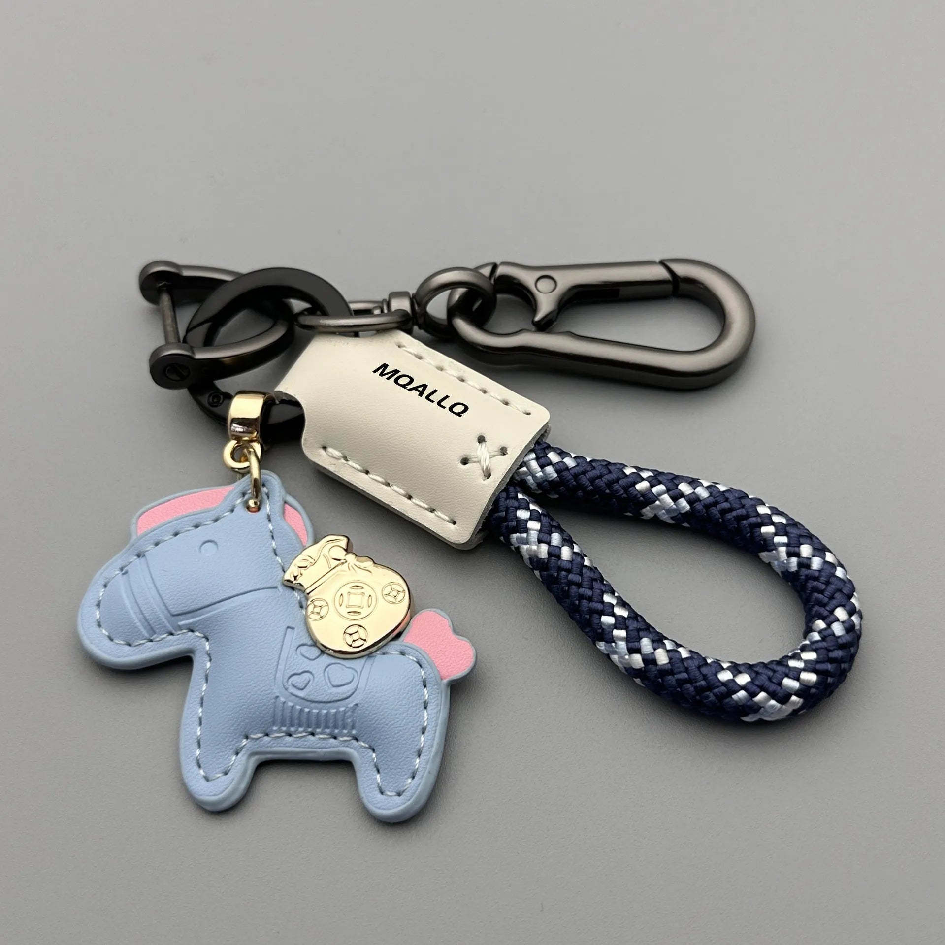 Handmade brown cowhide key pendant with a green flannel rope and a gold-toned horse-shaped buckle.