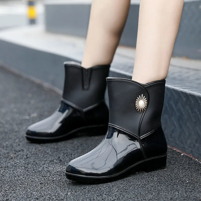 Women's mid-length PVC rain boots in purple, black, or beige with non-slip sole
