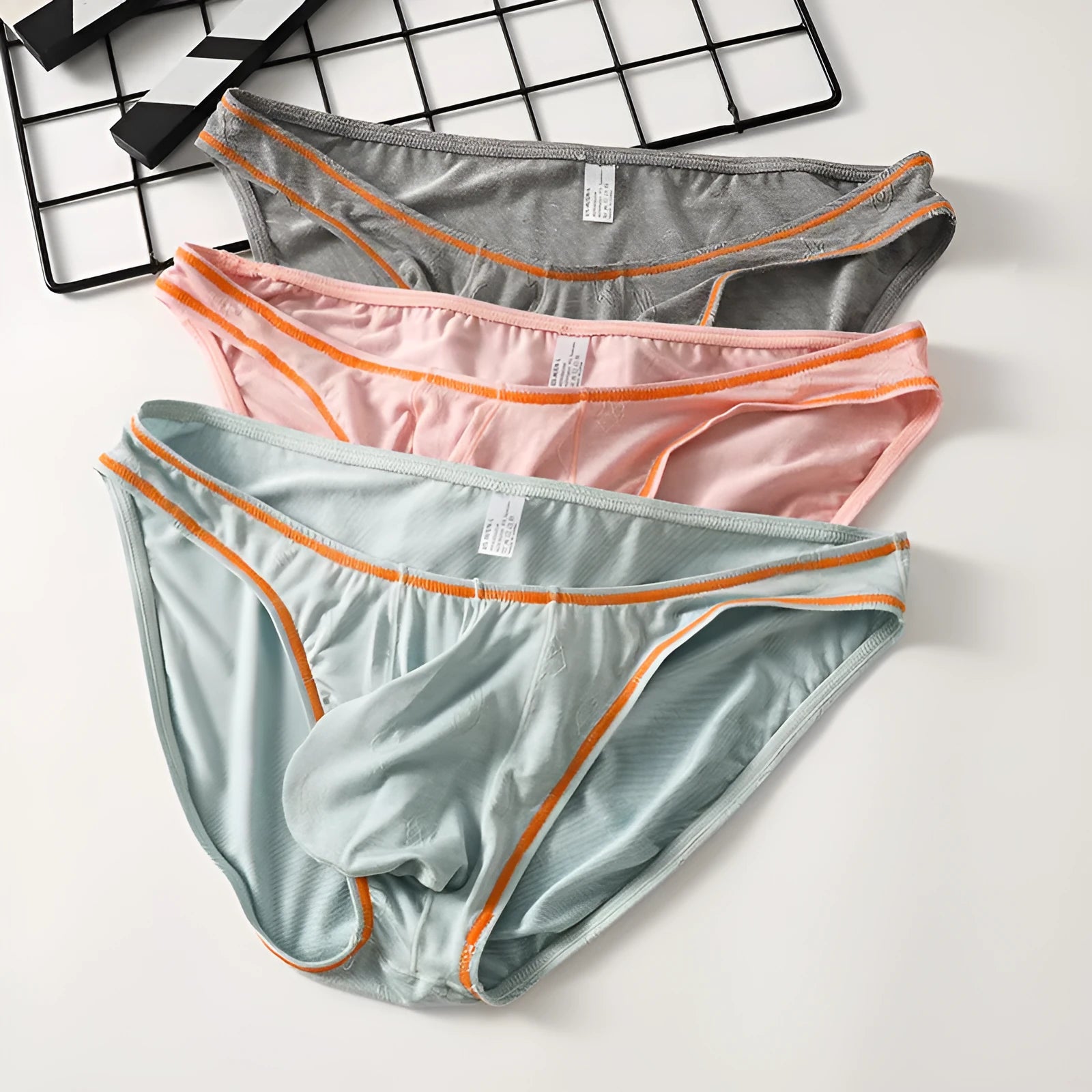 Men's dark grey modal hip-lift underwear with knitted ice silk fabric on a mannequin.