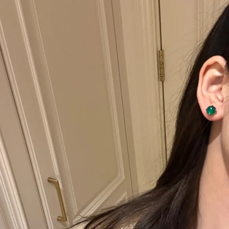 Chalcedony stud earrings with round egg stone in copper four-claw setting, emerald green colour
