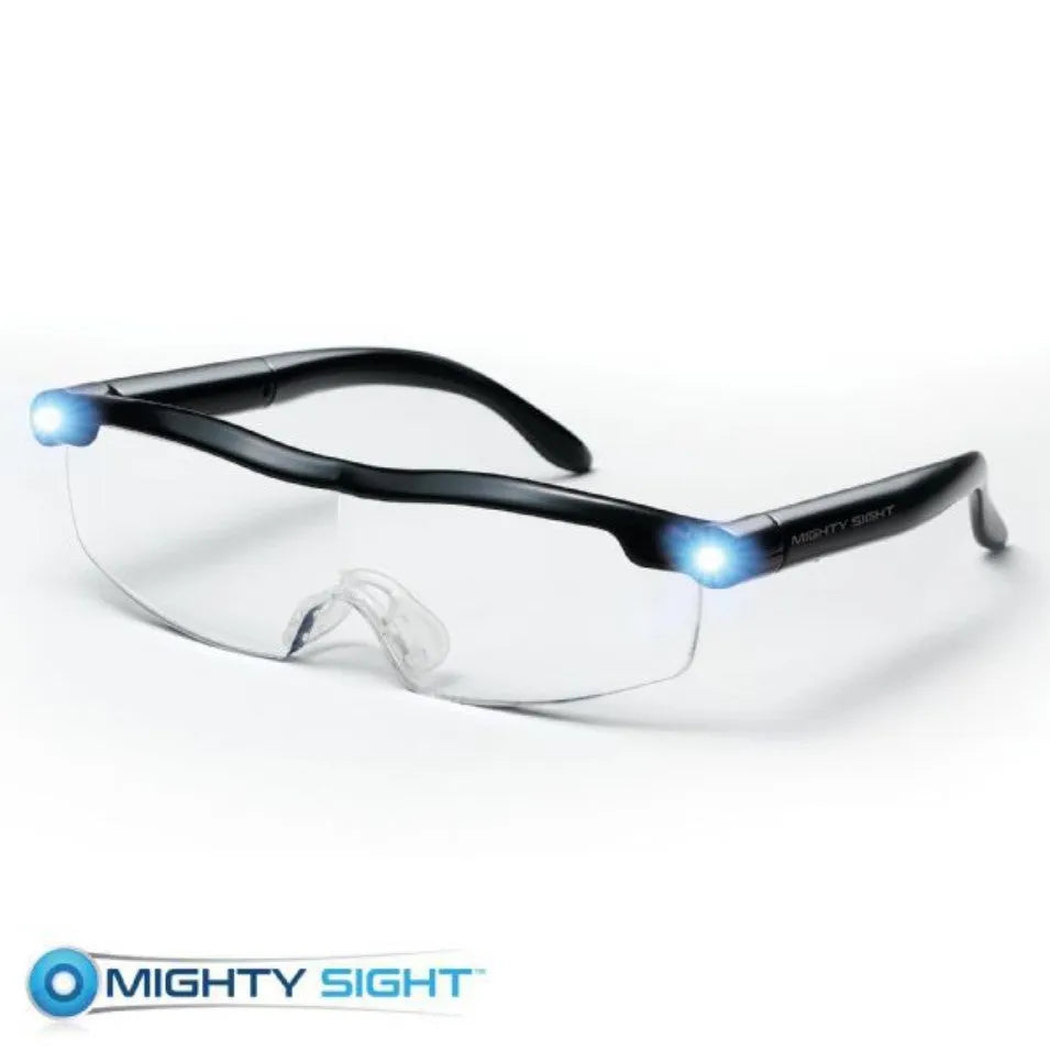 Transparent black USB LED light reading glasses with scheduled timer feature on a desk.