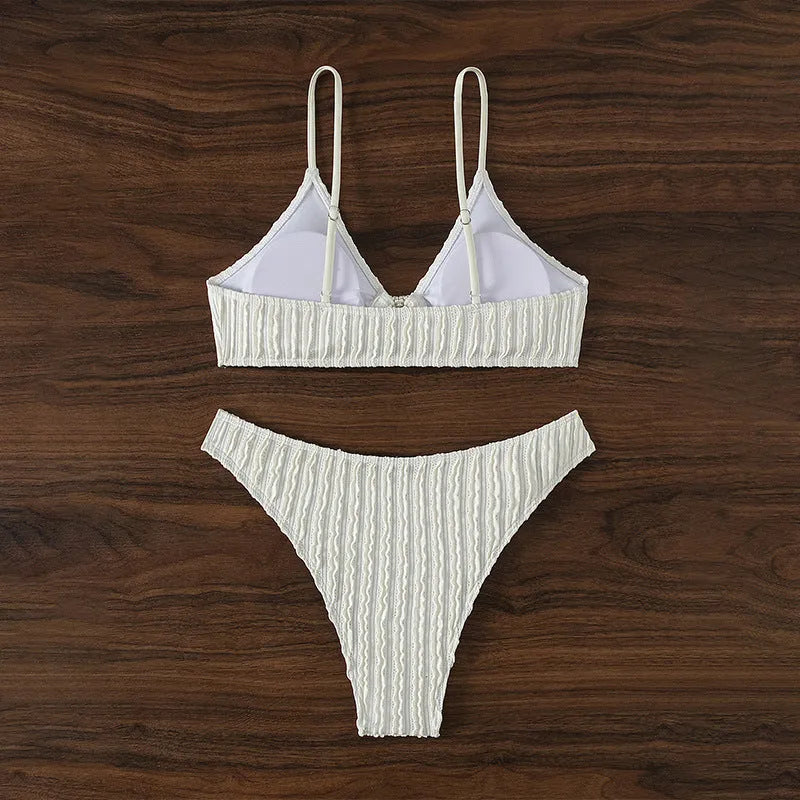 White women's V-neck beach swimsuit with split style and sleeveless design.