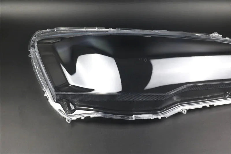Transparent plastic headlight housing cover for vehicle lighting protection