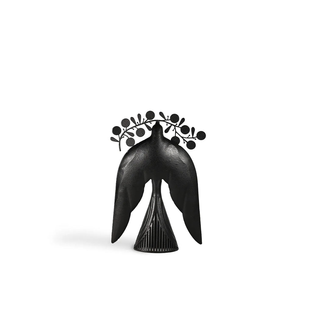 Handmade iron flying bird ornament in traditional Chinese style on a wooden surface.