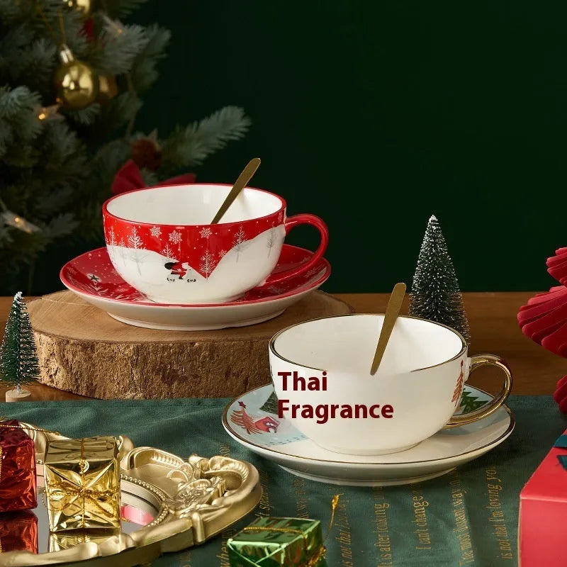 Ceramic gold-plated Christmas teapot set with snowflake design, including pot on dish and cup on dish with spoon, in gift box.