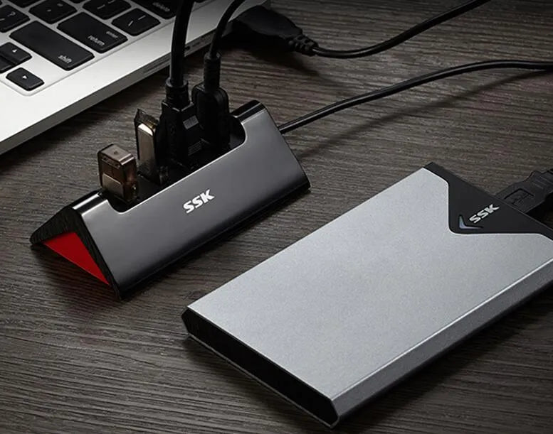 Black ABS plastic USB expansion dock with four ports showing Micro USB power connection