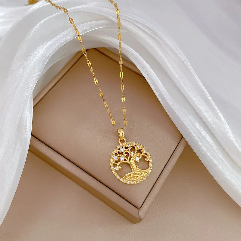 Gold-plated cross necklace with mother pearl inlay and rhinestone detailing on adjustable chain