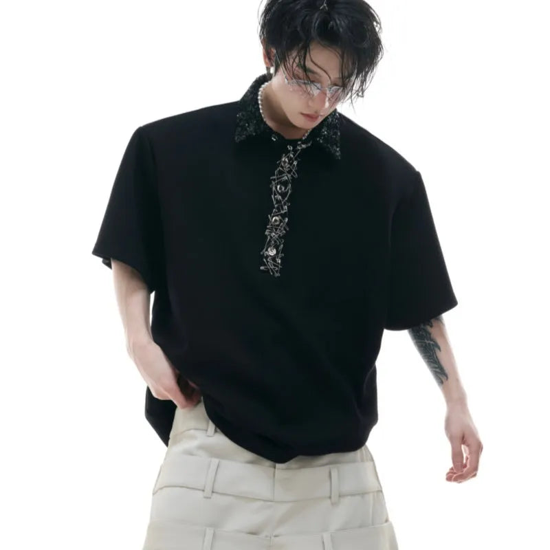 Men's black loose fit polo shirt with a square collar decorated with white embroidery and sequins.