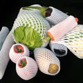 White foam net cover for fruit protection shown in various sizes on a table.
