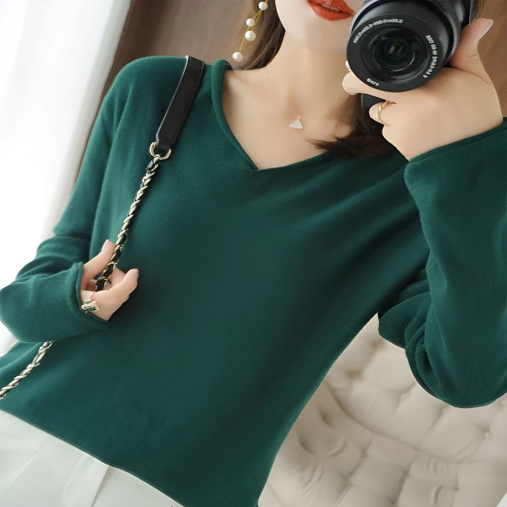 Women's V-neck long sleeve knitwear pullover top in a non-ironing material on a hanger.