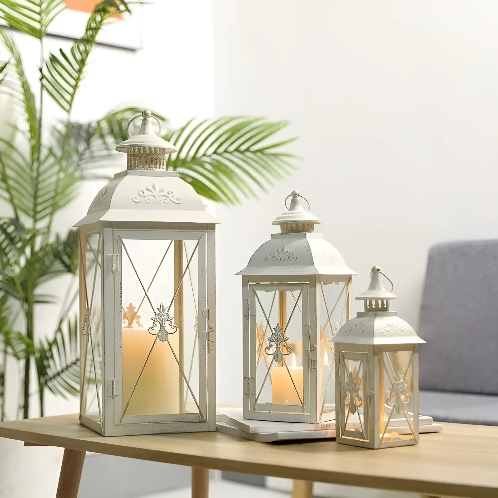 Black and white wrought iron floor-standing storm lantern with tempered glass in three sizes for courtyard use.