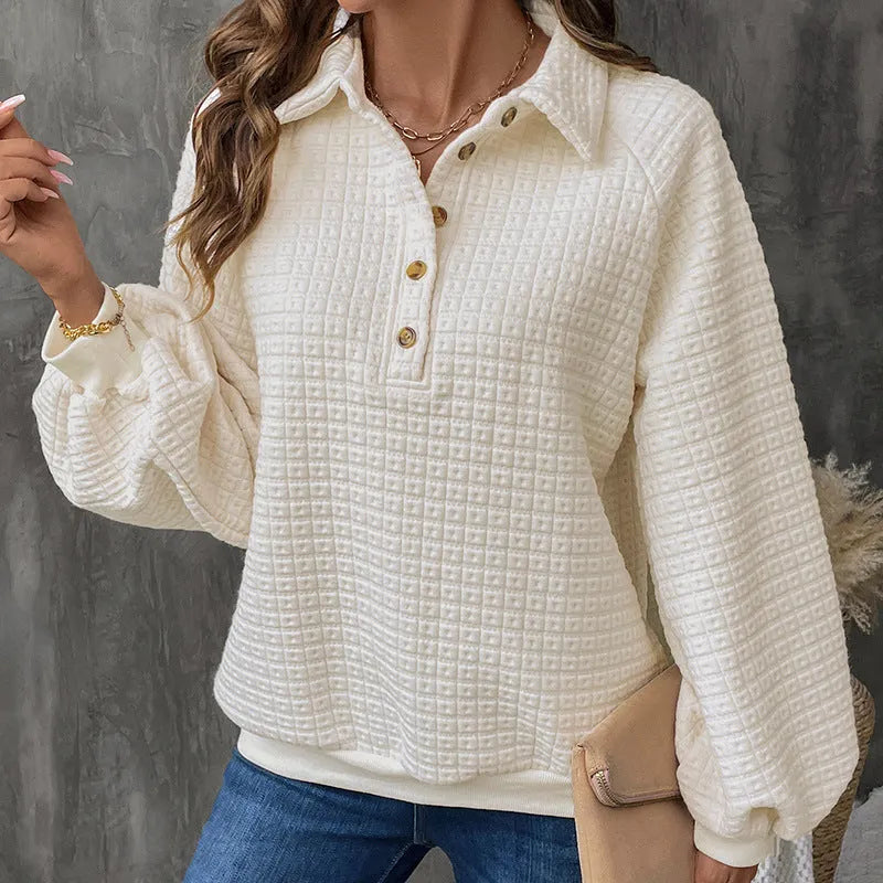 Women's milky white textured polo collar chunky knit sweater laid flat.