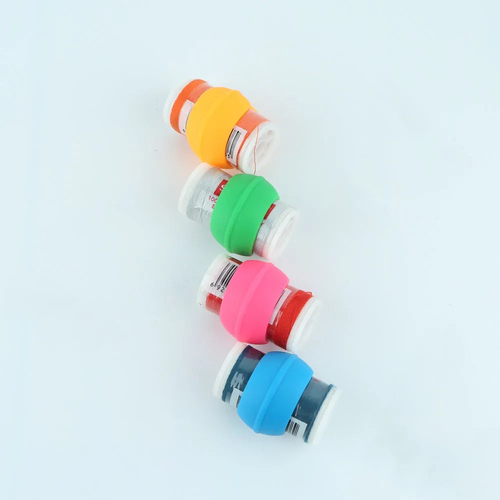 14 silicone sewing spool fixed clips in red, blue, orange, and green on a white background