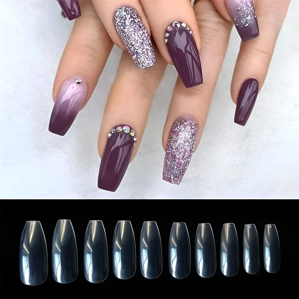 500 clear acrylic false nails in various sizes spread out on a table