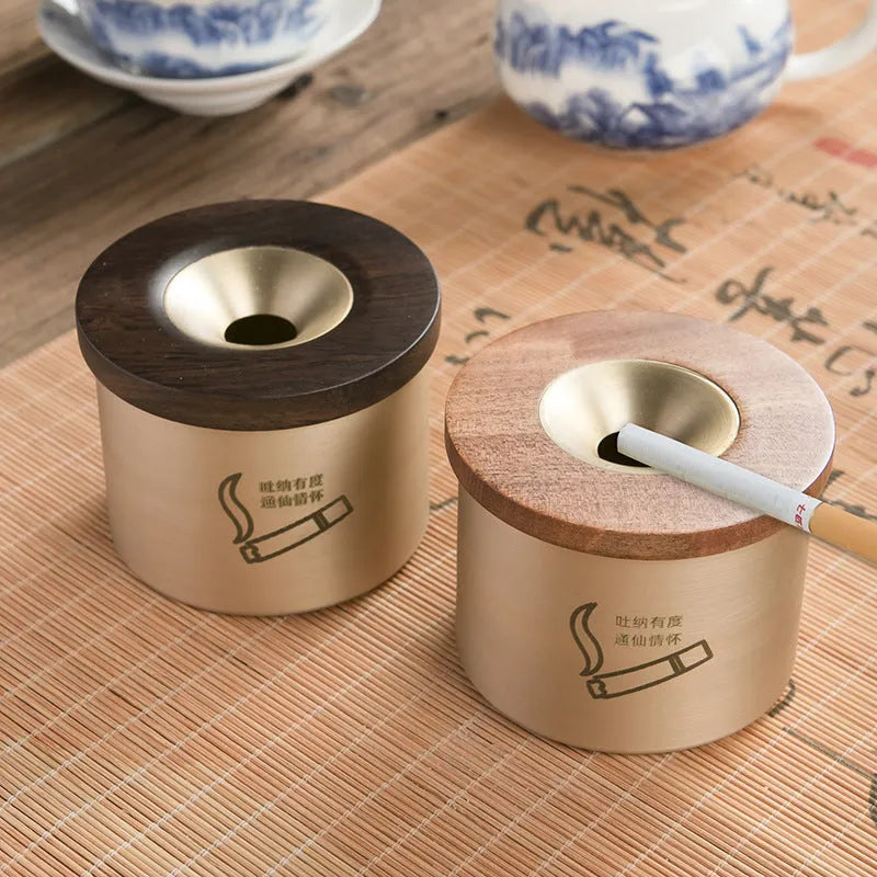 Retro brass-coloured copper ashtray with a wooden lid featuring a central hole