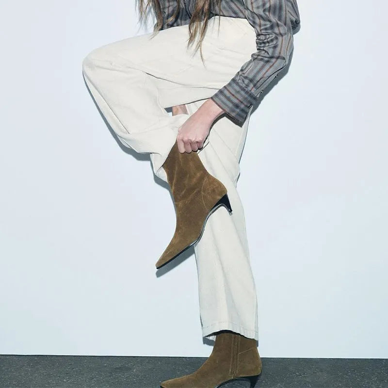 Brown women's square toe mid-calf boots with a side zipper and a low kitten heel on a wooden floor.