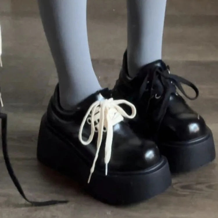 Women's matte black retro chunky sole lace-up ankle boots with a round toe on a white background.
