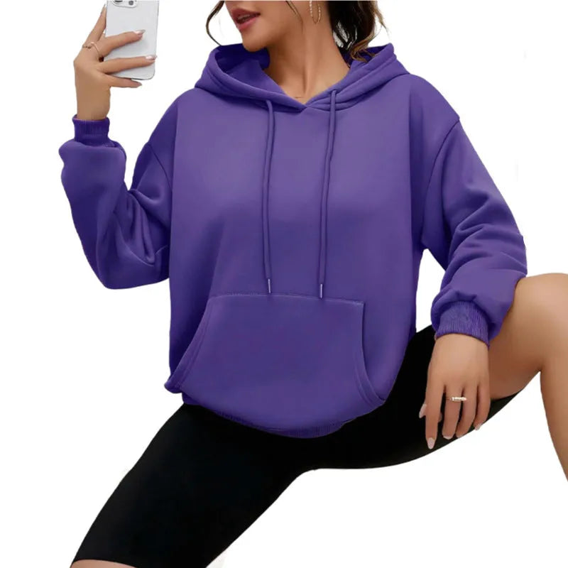 Women's loose grey drawstring hooded sweatshirt with side pockets, on a hanger.