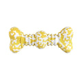Green, white, and yellow camouflaged natural rubber bone chew toy for large dogs on a plain background.