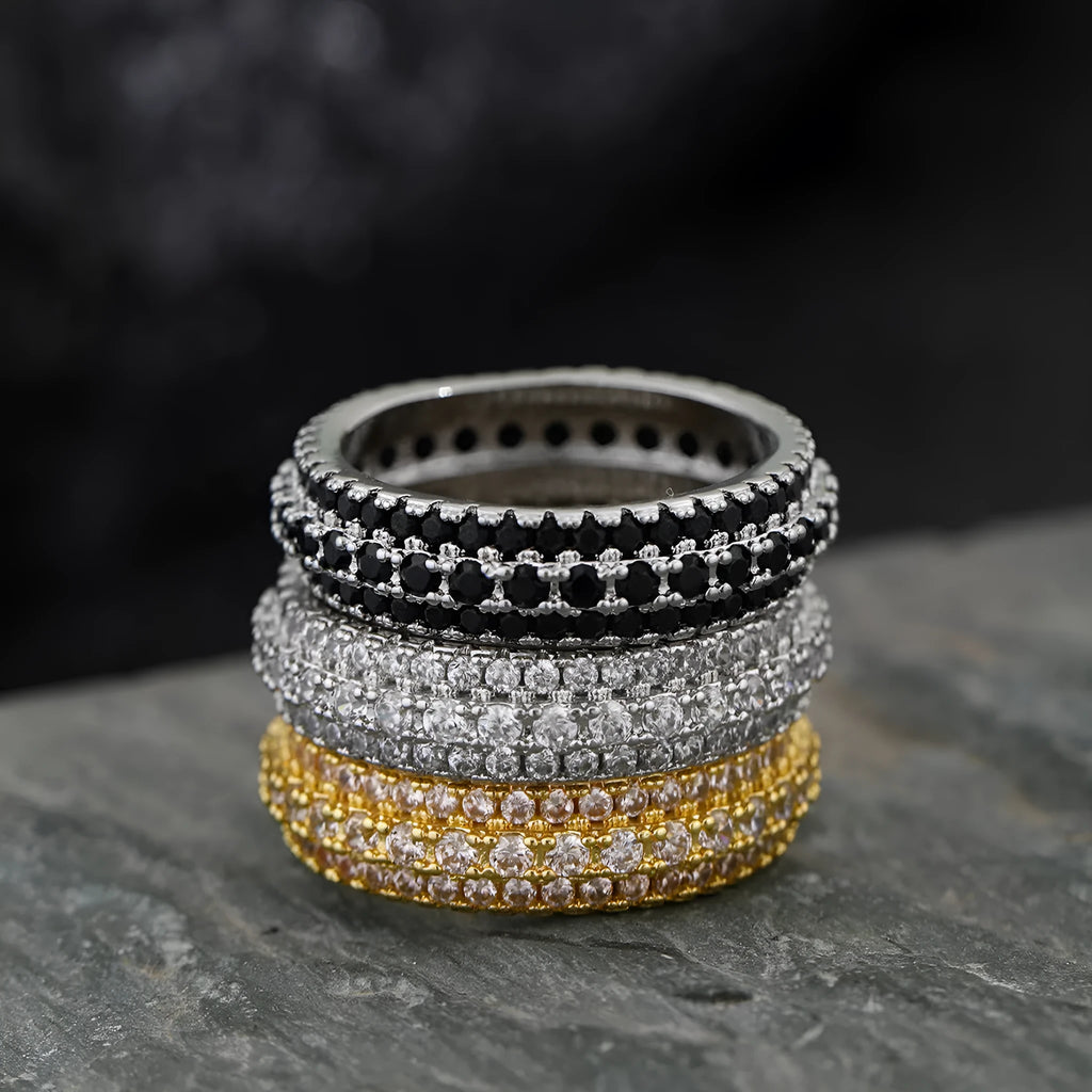 Geometric copper ring with triangle design and zircon stone inlay, shown in a choice of metallic finishes.