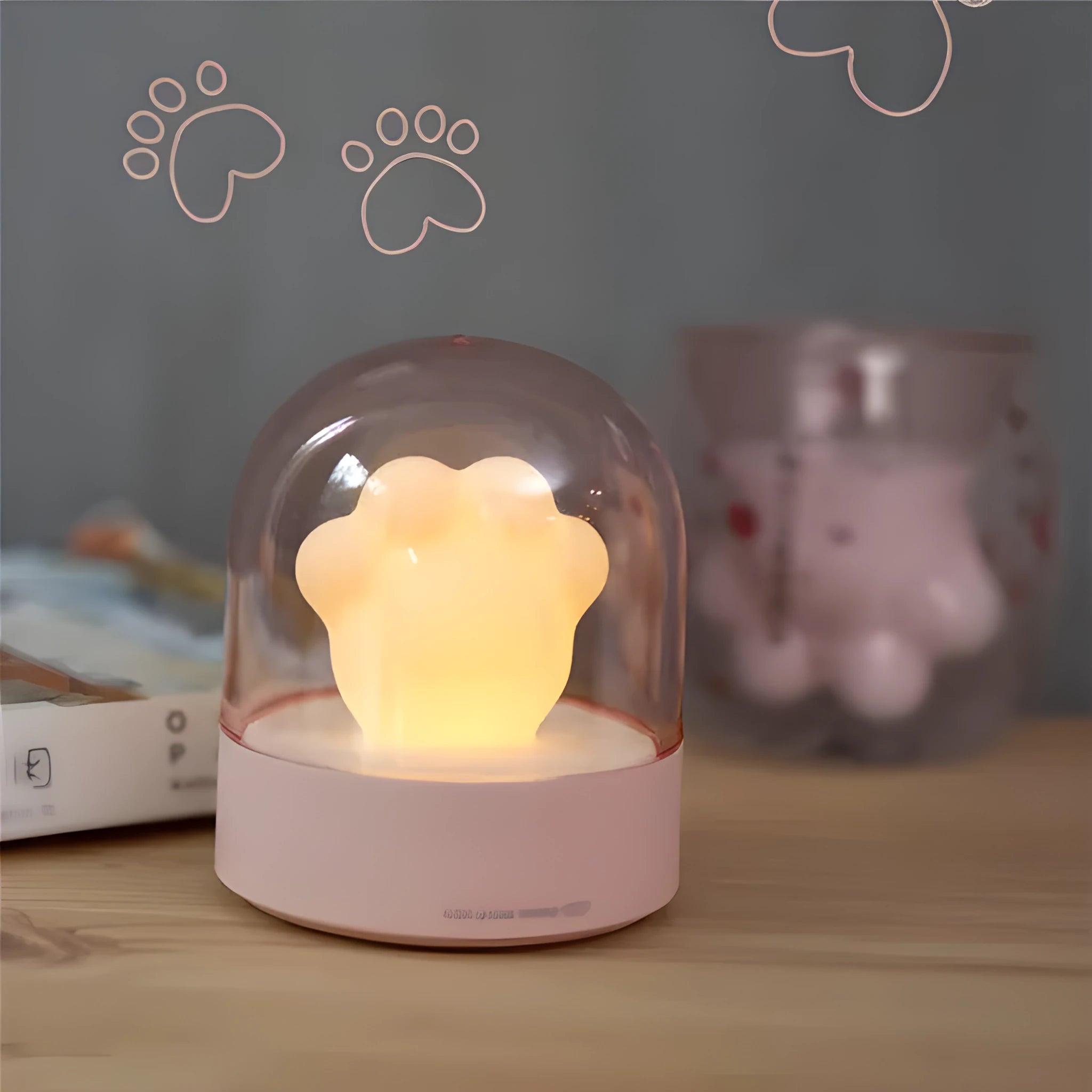 Grey cat paw shaped USB night light with rotating soft light and music box function on wooden desk