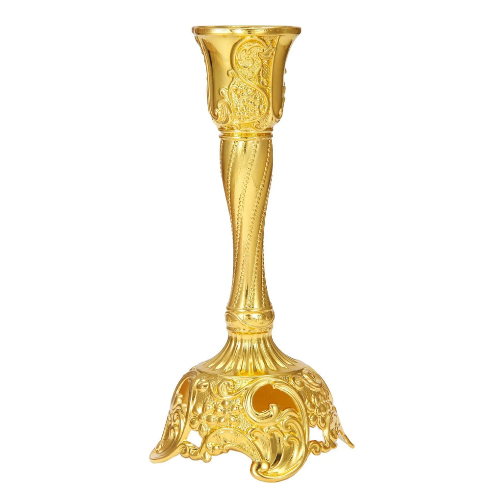 Small retro metal candlestick ornament in gold finish on a wedding table setting